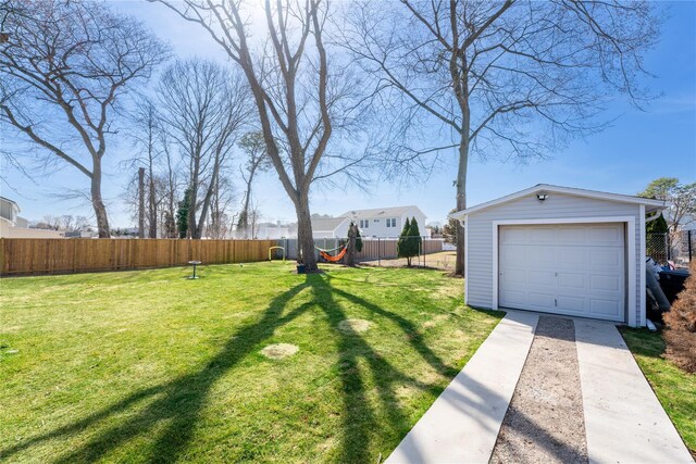 1760 Manatuck Blvd, Bay Shore, NY 11706 - view of yard with fence, a detached garage, an outdoor structure, and concrete driveway