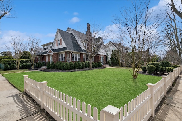 view of property exterior with brick siding, fence private yard, a yard, and a chimney