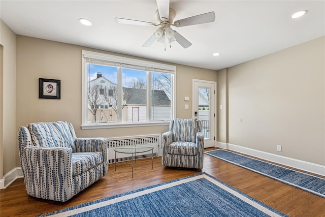 living area with radiator, recessed lighting, baseboards, a ceiling fan, and wood finished floors