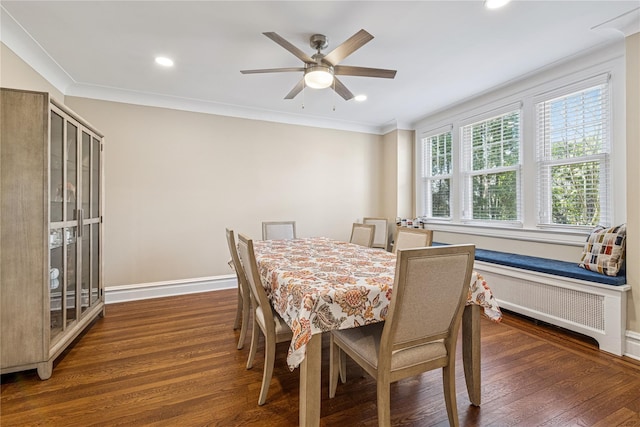 dining space with baseboards, ornamental molding, wood finished floors, and radiator