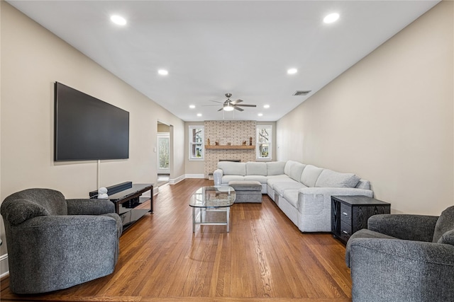 living area featuring recessed lighting, baseboards, ceiling fan, visible vents, and wood finished floors