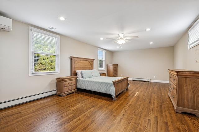 bedroom featuring wood finished floors, a baseboard heating unit, recessed lighting, and a baseboard radiator
