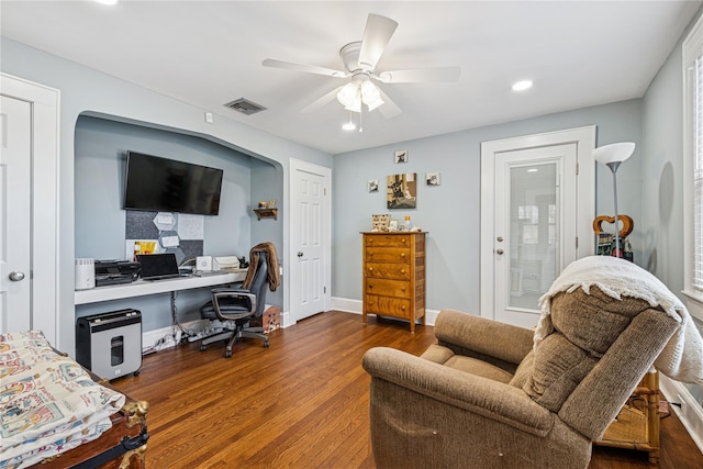 home office featuring baseboards, ceiling fan, visible vents, and wood finished floors