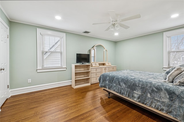 bedroom featuring recessed lighting, ornamental molding, baseboards, and wood finished floors
