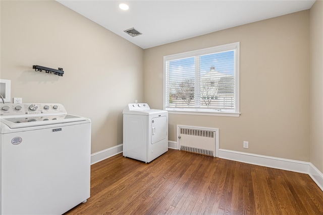 laundry room with washer and clothes dryer, radiator, laundry area, baseboards, and visible vents