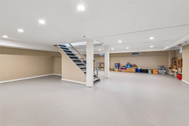 finished basement with stairs and recessed lighting