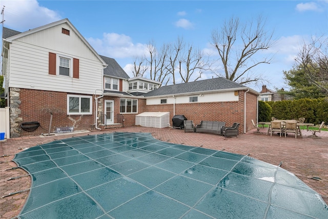 back of property featuring brick siding, fence, entry steps, and a patio area