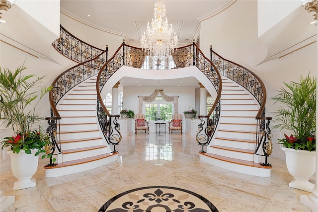 8 Tatem Way, Old Westbury, NY 11568 - foyer with a high ceiling, a chandelier, stairway, inlaid floor details, and ornamental molding