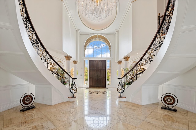 8 Tatem Way, Old Westbury, NY 11568 - entryway with a decorative wall, a high ceiling, stairs, a chandelier, and marble tiled floors