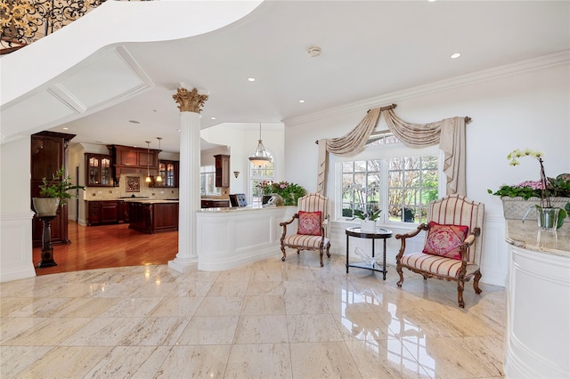 8 Tatem Way, Old Westbury, NY 11568 - sitting room with ornate columns, crown molding, a wainscoted wall, and a decorative wall