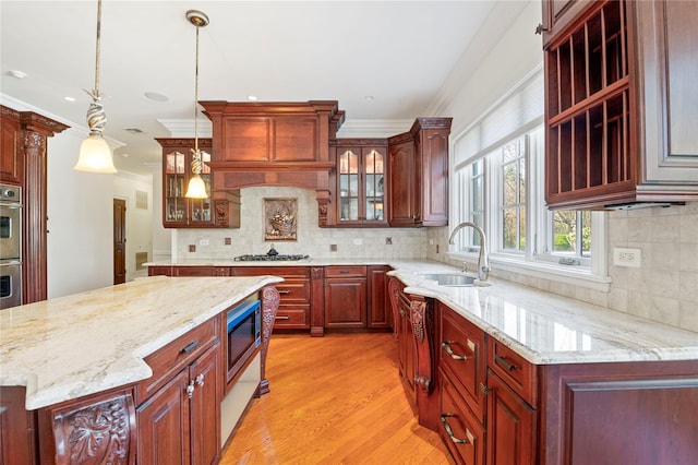 8 Tatem Way, Old Westbury, NY 11568 - kitchen with a sink, crown molding, stainless steel appliances, light wood-style floors, and glass insert cabinets
