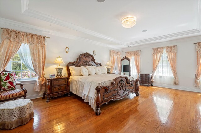 8 Tatem Way, Old Westbury, NY 11568 - bedroom featuring a tray ceiling, light wood finished floors, crown molding, and baseboards