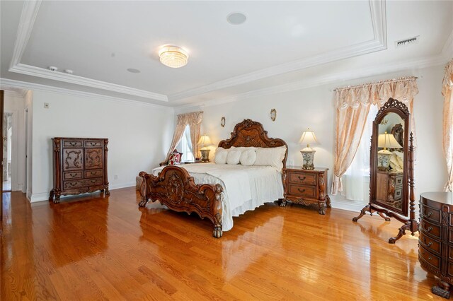 8 Tatem Way, Old Westbury, NY 11568 - bedroom with a tray ceiling, light wood finished floors, ornamental molding, and baseboards