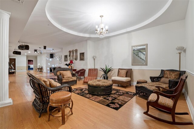 8 Tatem Way, Old Westbury, NY 11568 - living room with a chandelier, wood finished floors, decorative columns, and baseboards