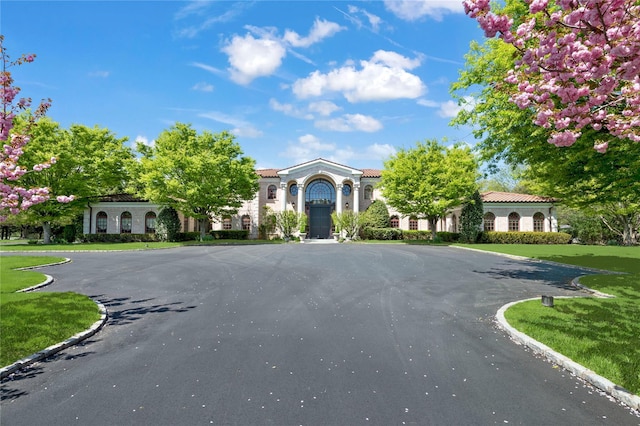 8 Tatem Way, Old Westbury, NY 11568 - view of front of property with curved driveway and a tiled roof