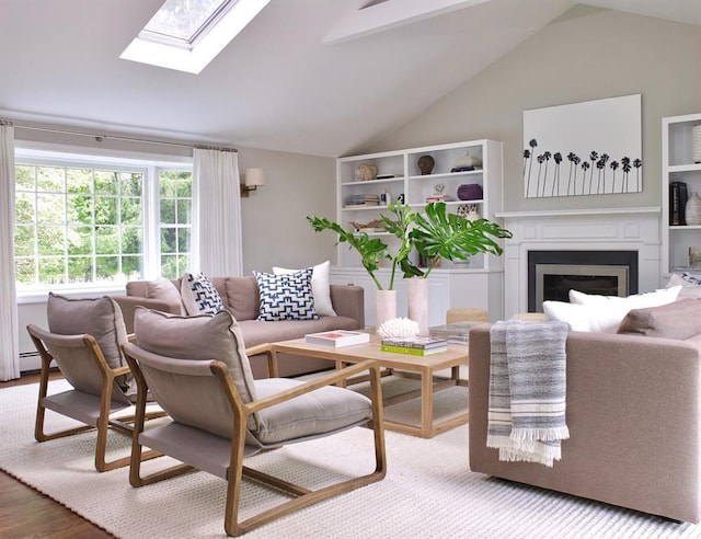 living area with lofted ceiling with skylight, wood finished floors, and a fireplace