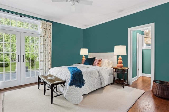 bedroom featuring french doors, crown molding, wood finished floors, baseboards, and access to outside