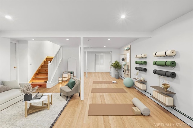 workout area featuring light wood-style floors and recessed lighting