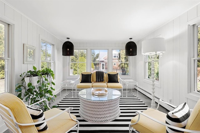 sunroom featuring ornamental molding, a wealth of natural light, and baseboard heating