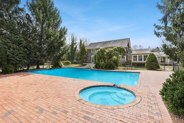 view of pool with an in ground hot tub, fence, and a fenced in pool