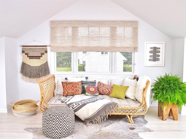 interior space with baseboards, vaulted ceiling, and wood finished floors