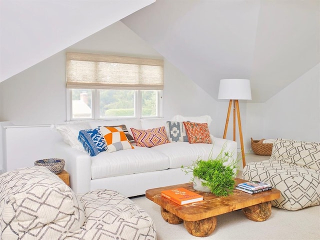 living area featuring carpet flooring and vaulted ceiling
