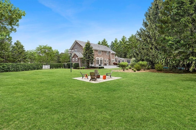 view of yard with a patio area, an outdoor fire pit, and fence