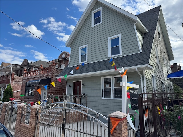 27-16 Mcintosh St, East Elmhurst, NY 11369 - view of front facade featuring roof with shingles, a gate, and a fenced front yard