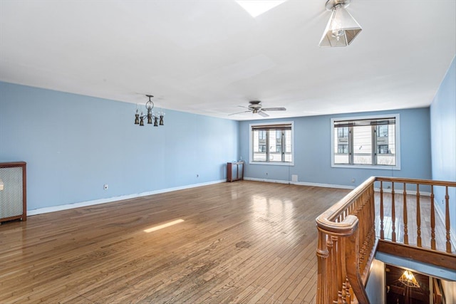 83-18 Parsons Blvd, Jamaica, NY 11431 - empty room with baseboards, radiator, wood finished floors, and ceiling fan with notable chandelier