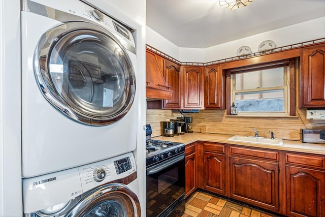 83-18 Parsons Blvd, Jamaica, NY 11431 - kitchen featuring light countertops, black gas range, tasteful backsplash, and stacked washing maching and dryer