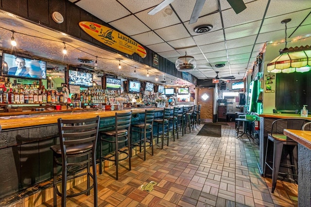 83-18 Parsons Blvd, Jamaica, NY 11431 - bar featuring visible vents, a bar, ceiling fan, and a drop ceiling