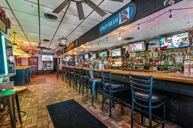 83-18 Parsons Blvd, Jamaica, NY 11431 - bar featuring a drop ceiling, a bar, visible vents, and a ceiling fan