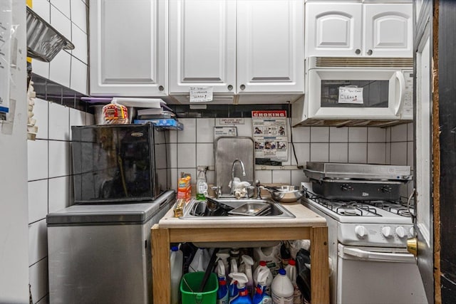 83-18 Parsons Blvd, Jamaica, NY 11431 - kitchen with white cabinetry, white appliances, tasteful backsplash, and a sink
