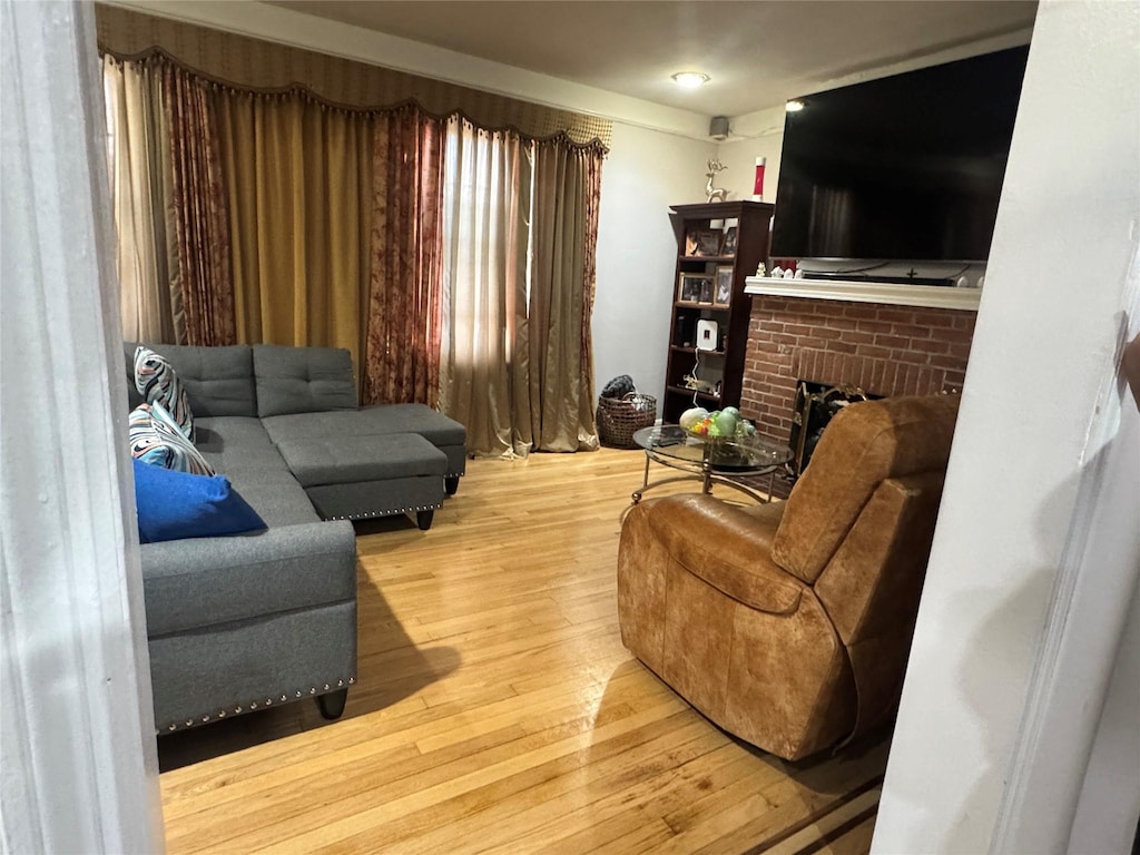 945 E 222nd St, Bronx, NY 10469 - living room with hardwood / wood-style flooring and a fireplace