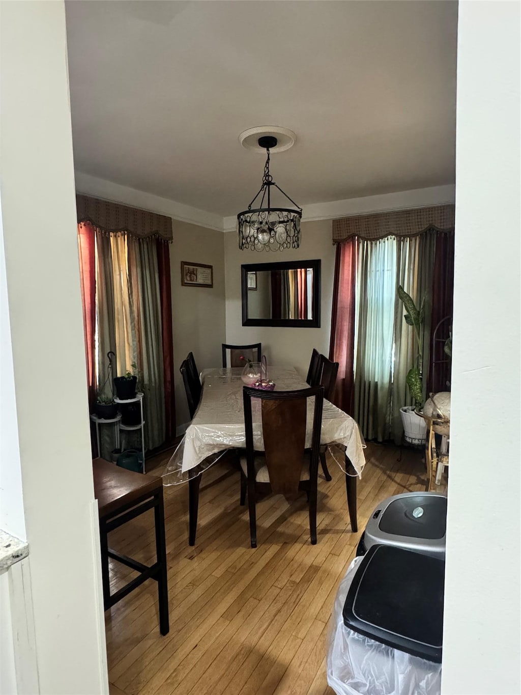 945 E 222nd St, Bronx, NY 10469 - dining space with light wood finished floors, a chandelier, and crown molding