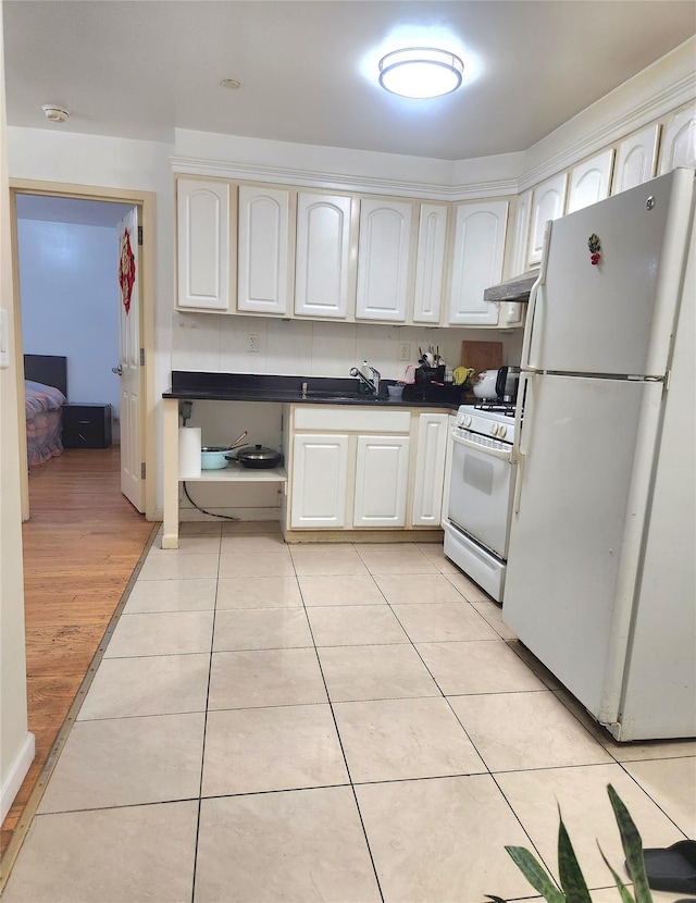 43-17 Union St Unit 2B, Flushing, NY 11355 - kitchen featuring white appliances, dark countertops, white cabinets, and light tile patterned flooring