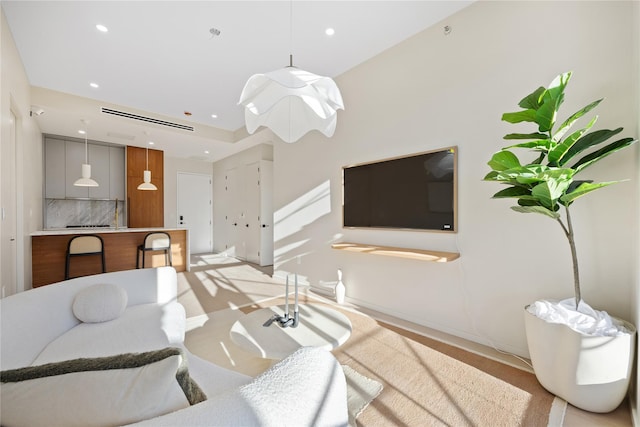 living room with recessed lighting, visible vents, and baseboards