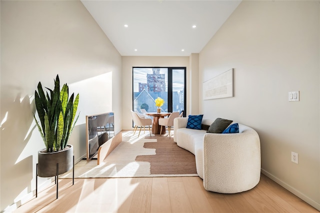 living room with recessed lighting, baseboards, and wood finished floors