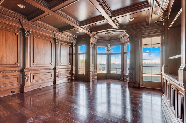 unfurnished room with a chandelier, crown molding, a water view, wooden ceiling, and coffered ceiling