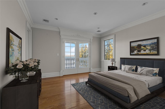 bedroom featuring light wood-style flooring, access to exterior, crown molding, french doors, and baseboards
