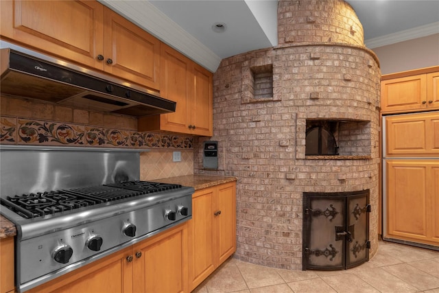 kitchen with stainless steel gas cooktop, ornamental molding, under cabinet range hood, light tile patterned flooring, and decorative backsplash