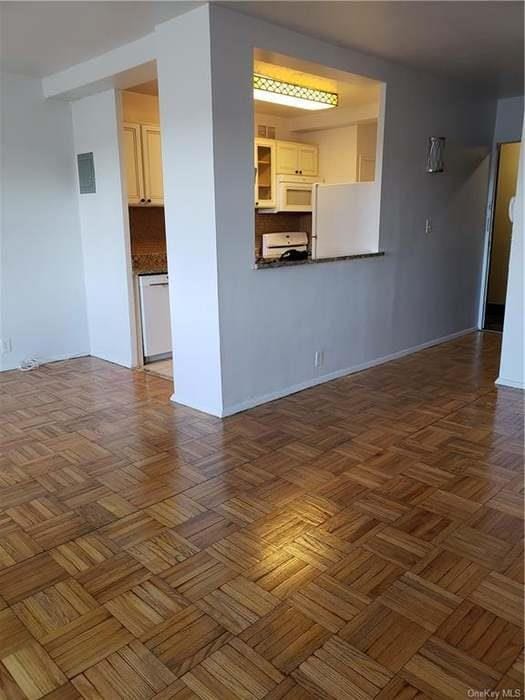 6 Fordham Hill Oval Unit 15F, Bronx, NY 10468 - unfurnished living room with baseboards