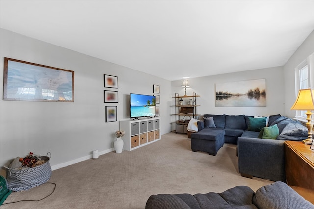 living room with baseboards and light carpet