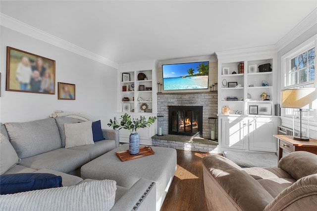 living area with crown molding, built in shelves, wood finished floors, and a fireplace