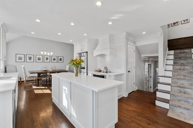 kitchen featuring dark wood-style flooring, a center island, premium range hood, recessed lighting, and white cabinetry