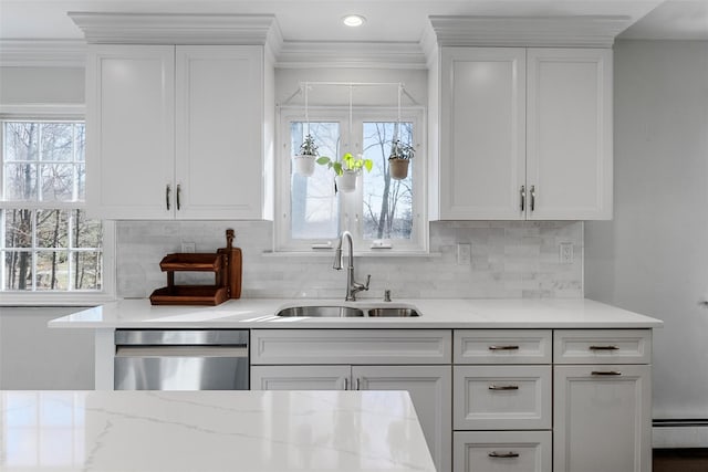 kitchen featuring a sink, crown molding, stainless steel dishwasher, and white cabinets