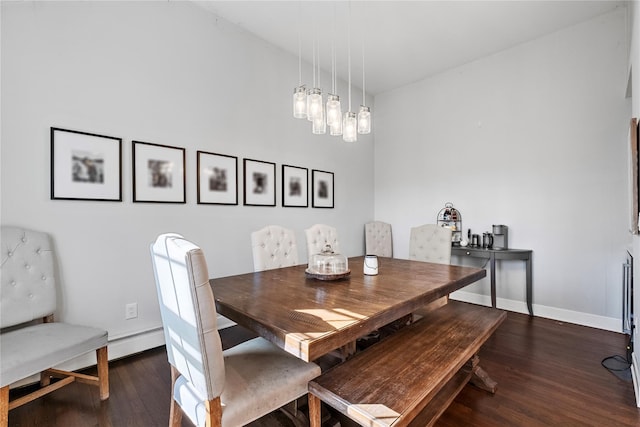 dining area with baseboards and wood finished floors