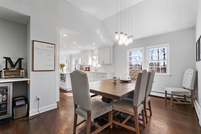 dining room featuring dark wood-style flooring, wine cooler, baseboards, a chandelier, and a baseboard radiator