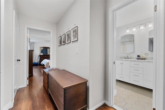 hallway with baseboards and wood finished floors