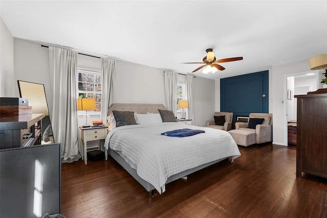 bedroom with a ceiling fan and dark wood finished floors